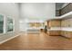 Open-concept living space with wood floors and bright, modern kitchen at 3370 Backdrop Ct, Castle Rock, CO 80108