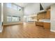 Bright, open-concept living space featuring wood floors and lots of windows at 3370 Backdrop Ct, Castle Rock, CO 80108