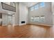 Bright, open living room with large windows, fireplace, and wood floors at 3370 Backdrop Ct, Castle Rock, CO 80108