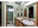 Bathroom with double vanity, granite countertops, and a separate toilet room and walk-in closet at 8277 Carriage Ln, Parker, CO 80134