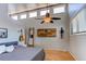 Bright bedroom featuring large windows, a ceiling fan, and unique decorative wall hangings at 8277 Carriage Ln, Parker, CO 80134