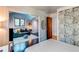 Open bedroom layout showing seamless flow into an adjacent living area and hardwood flooring at 8277 Carriage Ln, Parker, CO 80134