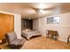 Basement bedroom with a comfortable bed, seating area, and ample natural light at 8277 Carriage Ln, Parker, CO 80134