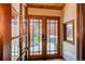 Inviting entryway featuring glass paneled front doors and a view to the outdoor porch at 8277 Carriage Ln, Parker, CO 80134