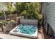 Backyard hot tub nestled on the deck next to mature landscaping and privacy fence at 8277 Carriage Ln, Parker, CO 80134