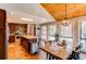 Modern kitchen featuring a central island, stainless steel appliances, and an adjacent breakfast area with bright windows at 8277 Carriage Ln, Parker, CO 80134