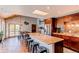 Spacious kitchen with a large island, modern appliances, wooden cabinets and adjacent breakfast nook at 8277 Carriage Ln, Parker, CO 80134