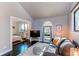 Stylish living room adjacent to a bedroom space, showcasing hardwood floors and bright windows at 8277 Carriage Ln, Parker, CO 80134