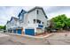 Charming townhouse with blue accents, attached garage, and well-maintained landscaping at 1372 S Cathay Ct # 104, Aurora, CO 80017