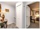 Bright hallway with carpeted floors, decorative lighting, and access to other rooms at 1372 S Cathay Ct # 104, Aurora, CO 80017