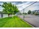 Community tennis court with fencing and well-maintained surface, surrounded by green lawns and mature trees at 1372 S Cathay Ct # 104, Aurora, CO 80017