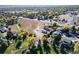 A captivating aerial view showing the lot, landscaping, and residential neighborhood with tree coverage in autumn colors at 6365 W Coal Mine Ave, Littleton, CO 80123