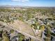 An aerial view showcases a neighborhood with streets, houses and trees in an open landscape at 6365 W Coal Mine Ave, Littleton, CO 80123