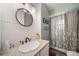 Charming bathroom features a vanity with granite countertop and a stylish oval mirror at 6365 W Coal Mine Ave, Littleton, CO 80123