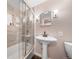 Bathroom featuring a shower with glass door, vanity with sink, and updated fixtures at 6365 W Coal Mine Ave, Littleton, CO 80123