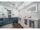 Bathroom with a stylish glass door shower, eye-catching tile and illuminated mirrors at 6365 W Coal Mine Ave, Littleton, CO 80123