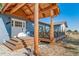 Charming entrance featuring a covered porch, wood steps, white trim, and a welcoming ambiance at 6365 W Coal Mine Ave, Littleton, CO 80123