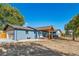 Charming blue home featuring a well-maintained front yard, inviting porch, and an attached garage at 6365 W Coal Mine Ave, Littleton, CO 80123