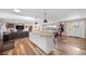 Open living area with wood floors connects seamlessly to the kitchen and dining space at 6365 W Coal Mine Ave, Littleton, CO 80123