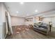 Spacious living room featuring modern flooring, area rug, and comfortable gray couch at 6365 W Coal Mine Ave, Littleton, CO 80123