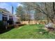 Backyard features deck with dining set, mature trees and lush green lawn at 15357 Flowergate Way, Parker, CO 80134