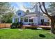 Backyard with wooden deck, dining set, hot tub, mature trees and manicured lawn at 15357 Flowergate Way, Parker, CO 80134