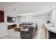 Finished basement with comfortable seating, wet bar, and ample lighting at 15357 Flowergate Way, Parker, CO 80134