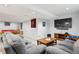 Finished basement features a plush gray sectional couch, a pool table and a large TV at 15357 Flowergate Way, Parker, CO 80134