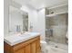 Bathroom features tiled shower with glass doors and a wood vanity with white countertop at 15357 Flowergate Way, Parker, CO 80134