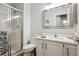 Bathroom featuring a glass-enclosed shower, white vanity, and a large mirror at 15357 Flowergate Way, Parker, CO 80134