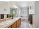 Large bathroom with double sinks, soaking tub, and tile floors at 15357 Flowergate Way, Parker, CO 80134