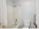 Bright bathroom with a shower-tub combination and white tile at 15357 Flowergate Way, Parker, CO 80134