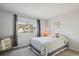 Bedroom with natural light, a large window, and cozy decor at 15357 Flowergate Way, Parker, CO 80134