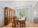 Bright dining room with hardwood floors, a classic china cabinet, and large windows at 15357 Flowergate Way, Parker, CO 80134