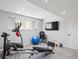 Exercise room features a stationary bike, weight machines, a flat screen TV and a fitness ball at 15357 Flowergate Way, Parker, CO 80134