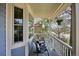 Inviting front porch with rocking chairs and a hanging flower basket; perfect for relaxing at 15357 Flowergate Way, Parker, CO 80134