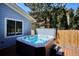 Backyard features a hot tub on the deck, along with a privacy fence and landscaping at 15357 Flowergate Way, Parker, CO 80134
