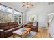 Open-concept living room with large windows and backyard views at 15357 Flowergate Way, Parker, CO 80134