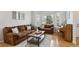 Comfortable living room featuring hardwood floors, natural light, and stylish furnishings at 15357 Flowergate Way, Parker, CO 80134