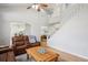 Spacious living room featuring hardwood floors, a ceiling fan, and a cozy leather sofa set at 15357 Flowergate Way, Parker, CO 80134