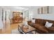 Open-concept living area flowing into the dining space with hardwood floors and natural light at 15357 Flowergate Way, Parker, CO 80134
