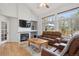 Cozy living room features a fireplace and large windows at 15357 Flowergate Way, Parker, CO 80134