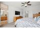 Bright main bedroom with ensuite bathroom featuring natural light, ceiling fan, and neutral decor at 15357 Flowergate Way, Parker, CO 80134