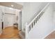 Bright foyer with white staircase, light hardwood flooring, and a view of the front door at 15357 Flowergate Way, Parker, CO 80134