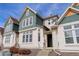 Inviting townhome exterior boasting a well-kept lawn, appealing architectural features, and natural light at 9612 W Indore Dr, Littleton, CO 80128