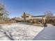 View of the home's backyard in winter with a covered patio at 9235 Quitman St, Westminster, CO 80031