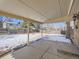 Covered patio overlooking a spacious backyard with snow at 9235 Quitman St, Westminster, CO 80031