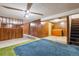 This finished basement has wood paneling, a ceiling fan and unique carpeting at 3052 S Joplin Ct, Aurora, CO 80013