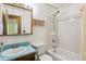 Functional bathroom featuring blue countertop, a framed mirror, framed art, toilet, and combination shower/tub at 3052 S Joplin Ct, Aurora, CO 80013