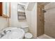 Cozy bathroom features a tiled shower, a toilet, and a sink with a mirror above at 3052 S Joplin Ct, Aurora, CO 80013